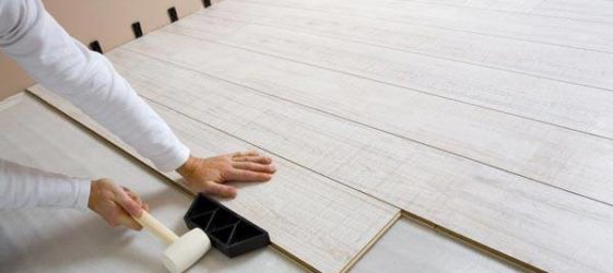 Taping laminate flooring with a rubber mallet